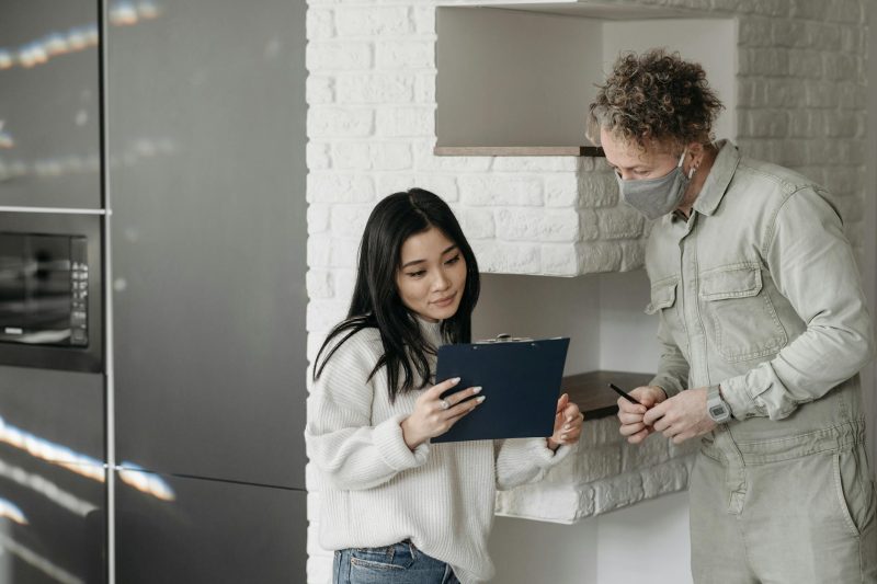 Masked courier and woman interacting indoors highlighting sa 1775581362