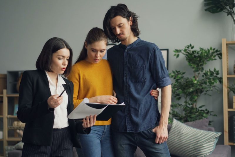 Home 10 A couple reviewing documents with a real estate agent indoor 1781629493