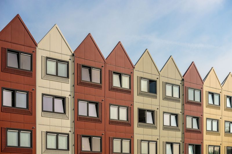 Home 15 A vibrant row of gableroofed residential buildings with meta 1782838821