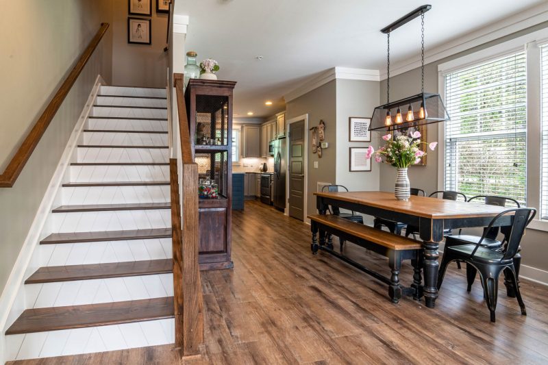 Home 13 Bright and inviting dining area features a wooden table stai 1784048529